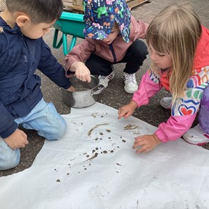 Children finger painting with mud