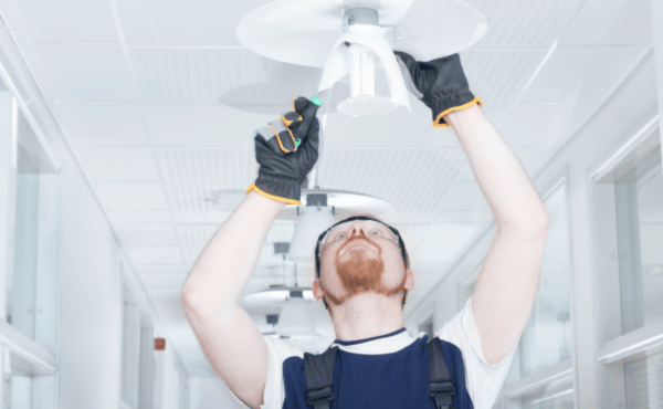 Technician fixing light fixture