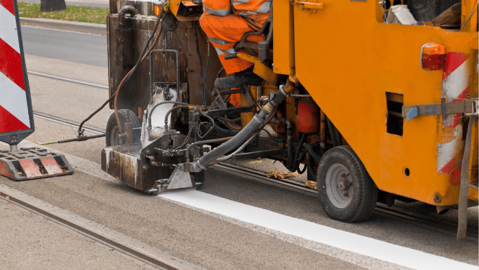 Road marking vehicle adding paint markings
