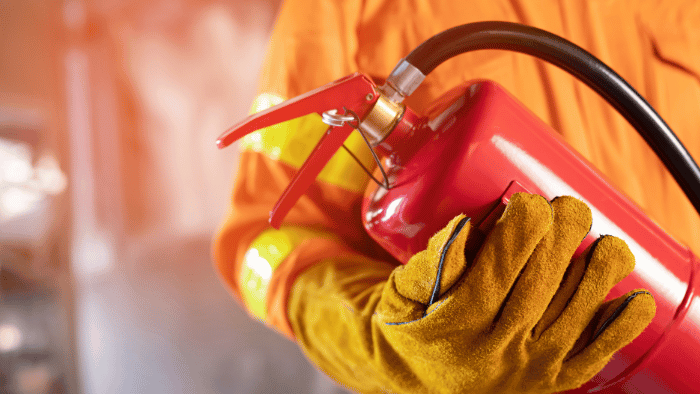 Person holding extinguisher