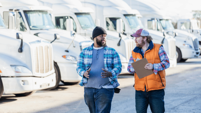 Workers consulting about vans