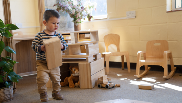 Toddler playing with box