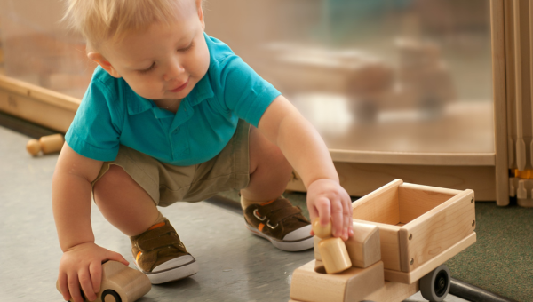 Child playing with wooden toy