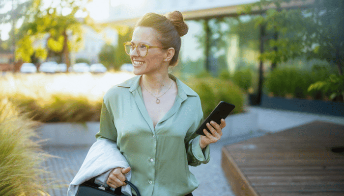Woman walking with phone in hand