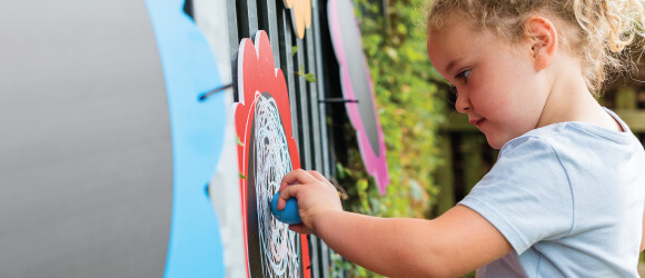 Girl using a chalkboard