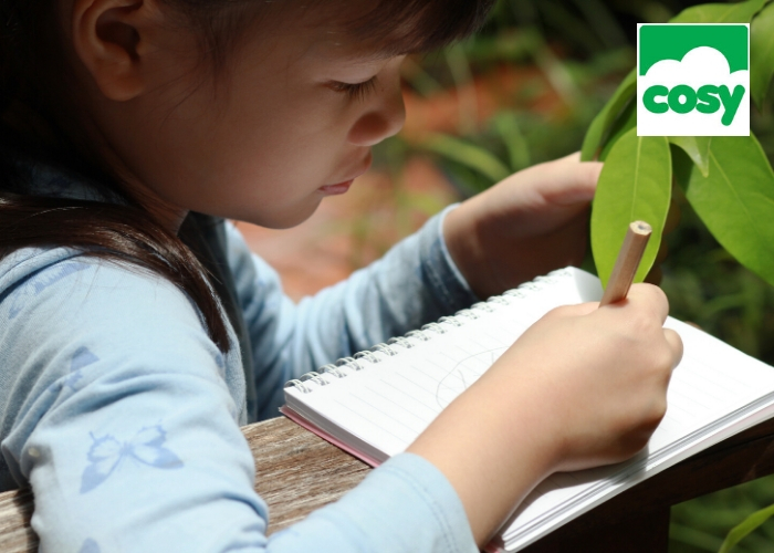 young girl drawing outside