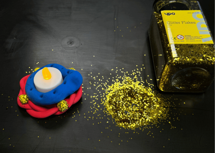 Homemade clay Diya lamp with glitter
