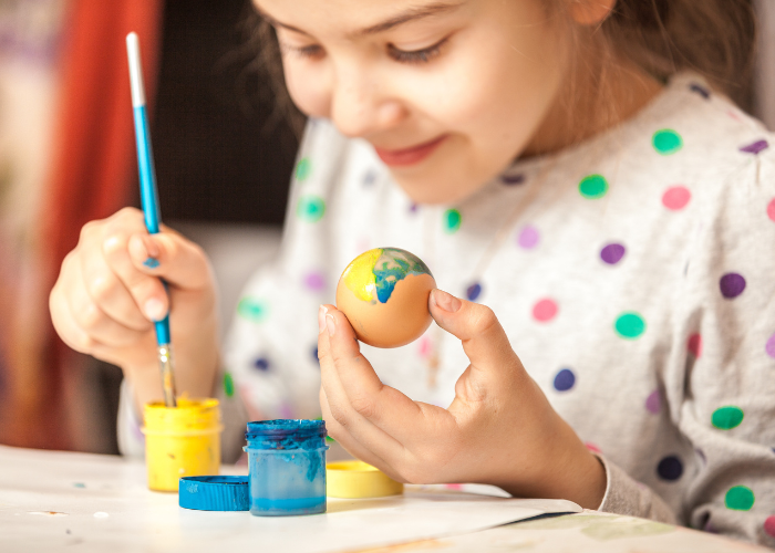 Girl painting egg 