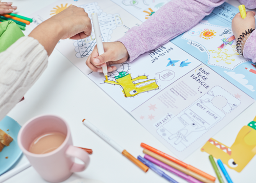 Child colouring in a colouring book