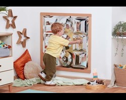 child playing with sensory mirror