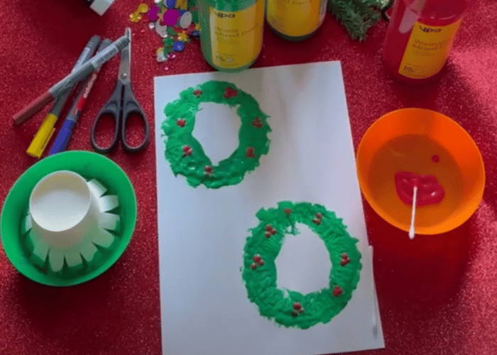 Green wreaths with holly painted on white card