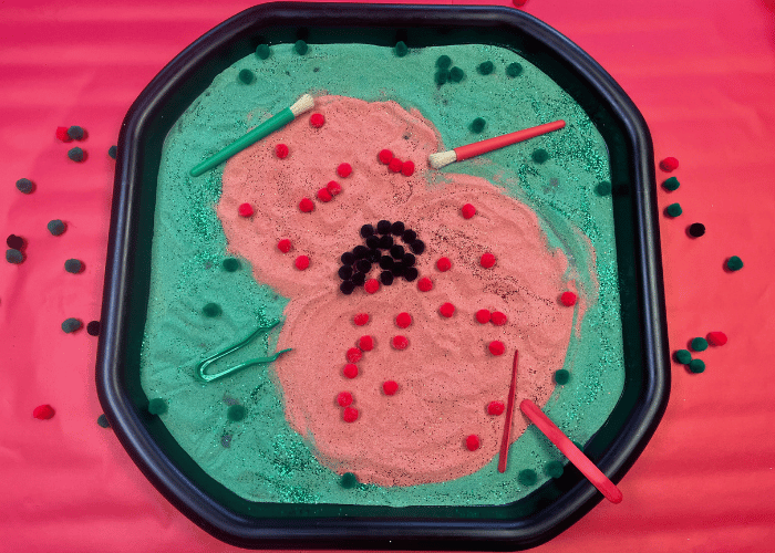 Poppy Tuff Tray created with red and green sand