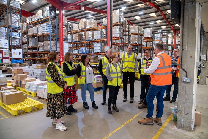 staff members in a warehouse wearing hi vis