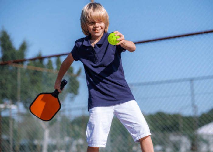 Child readying to make a serve during a pickleball match