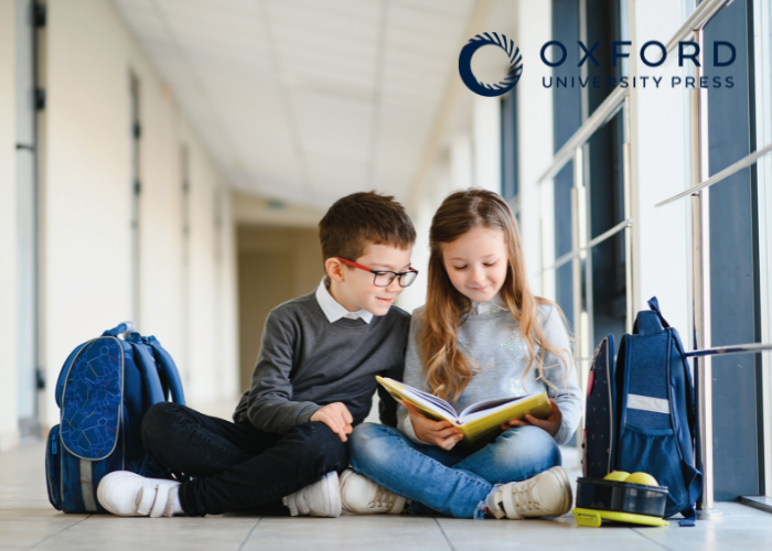 Two children reading a book together