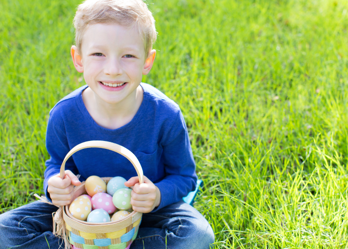 child holding easter eggs in a basket