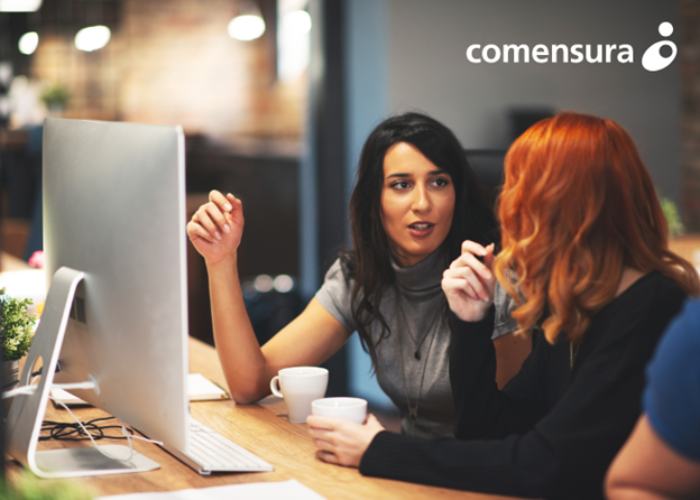 Two women speaking in an office environment 