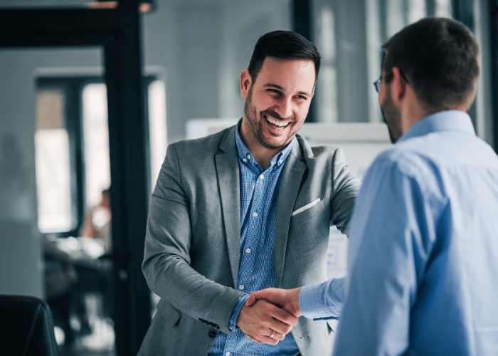 employer shaking hands with employee