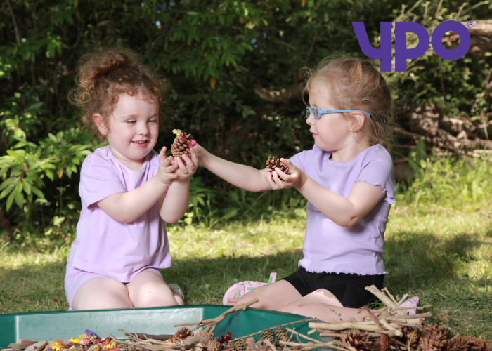 Children playing outside with play tray