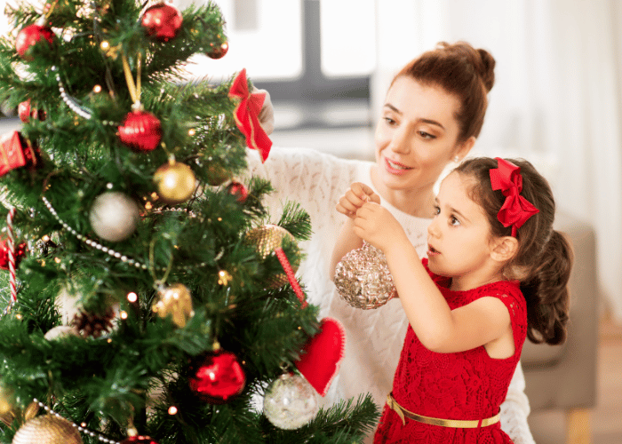 Girl decorating Christmas tree
