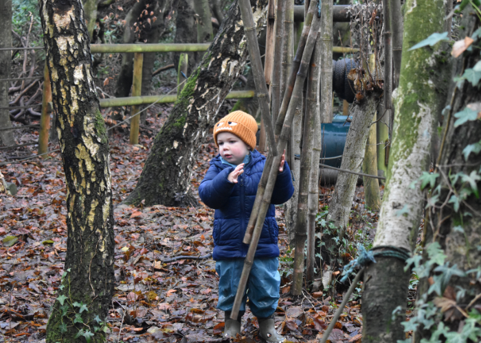 Child playing in woodland area 