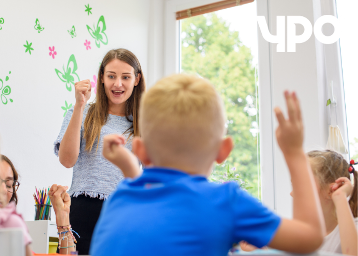 Children in a classroom engaging with their teacher