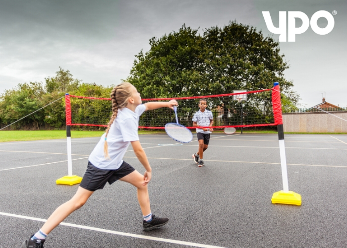 two primary school children playing badminton 