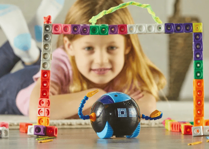 Image of a young girl playing with Cooper the STEM Robot