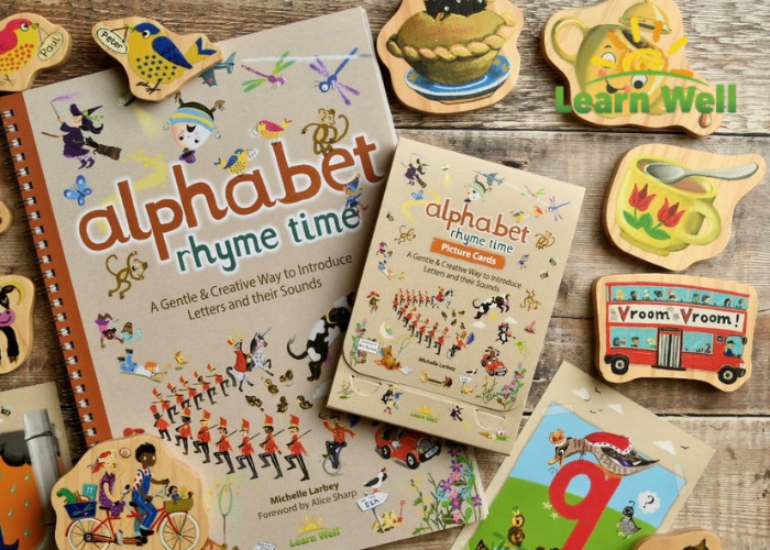 Books and other nursery rhyme learning resources on a wooden table