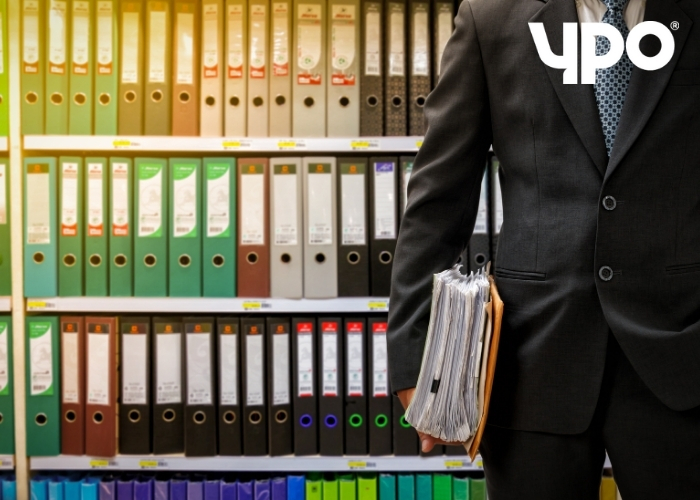 man standing with files