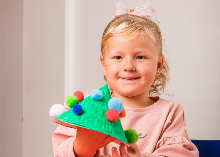 child holding christmas craft