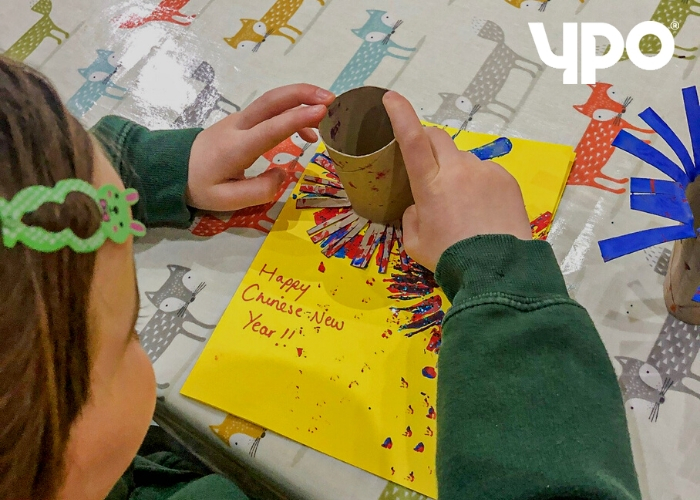young girl playing with paint and glitter