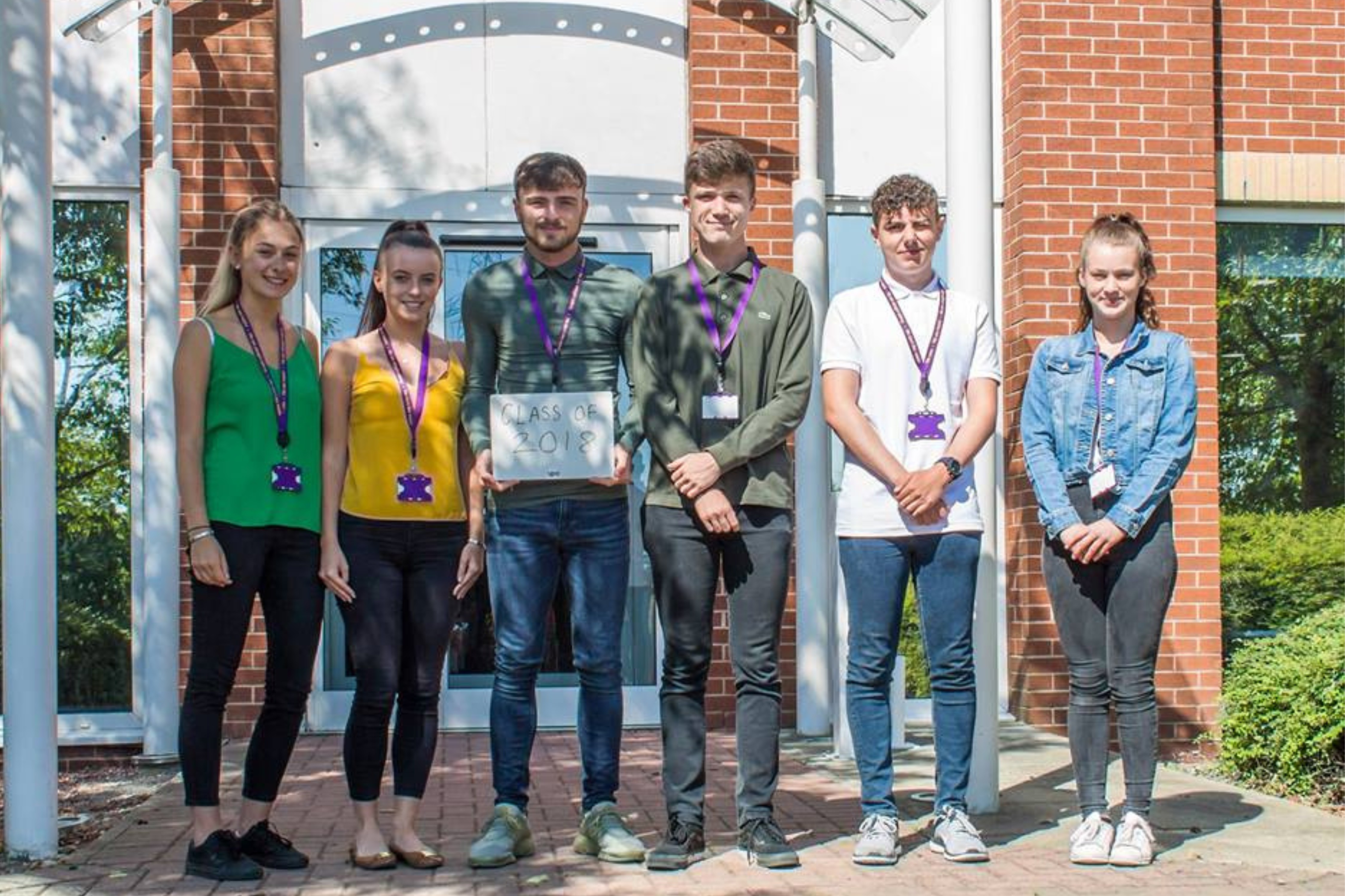 Group of apprentices standing outside building