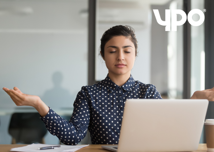 Woman managing her stress levels at work desk
